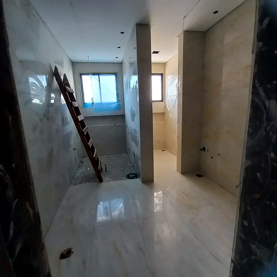 Suíte com porcelanato bege polido no piso e nas paredes